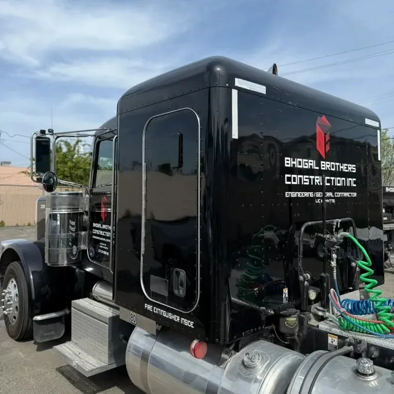 Black Bhogal Construction semi truck with white door lettering