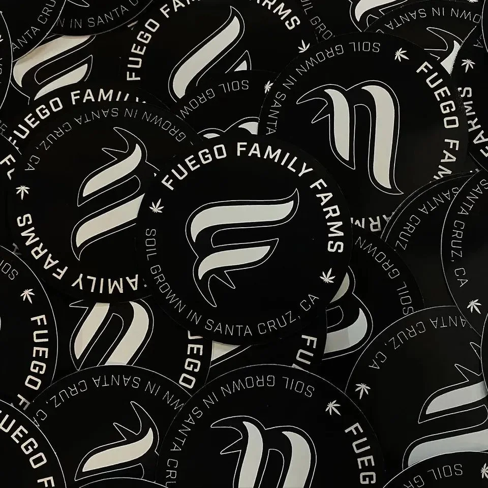 Pile of black Fuego Family Farms circle stickers