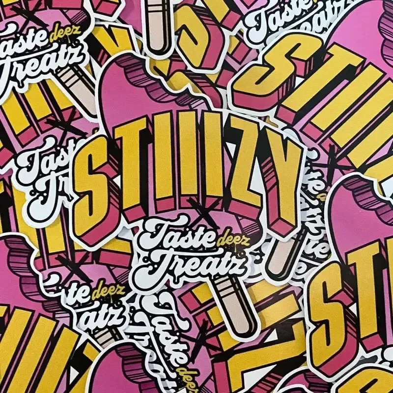 Pile of pink and yellow Taste Deez Treatz × STIIIZY die-cut stickers