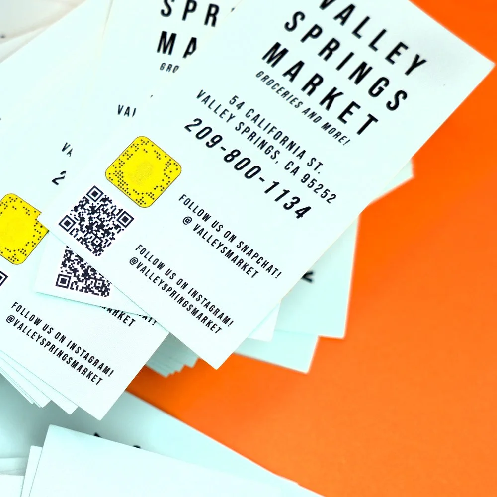 A fanned stack of printed business cards on an orange background