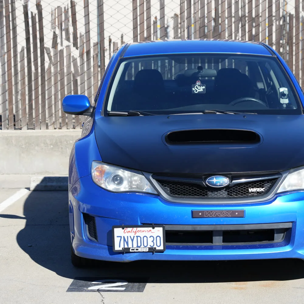 Blue Subaru WRX with a finished matte black hood wrap