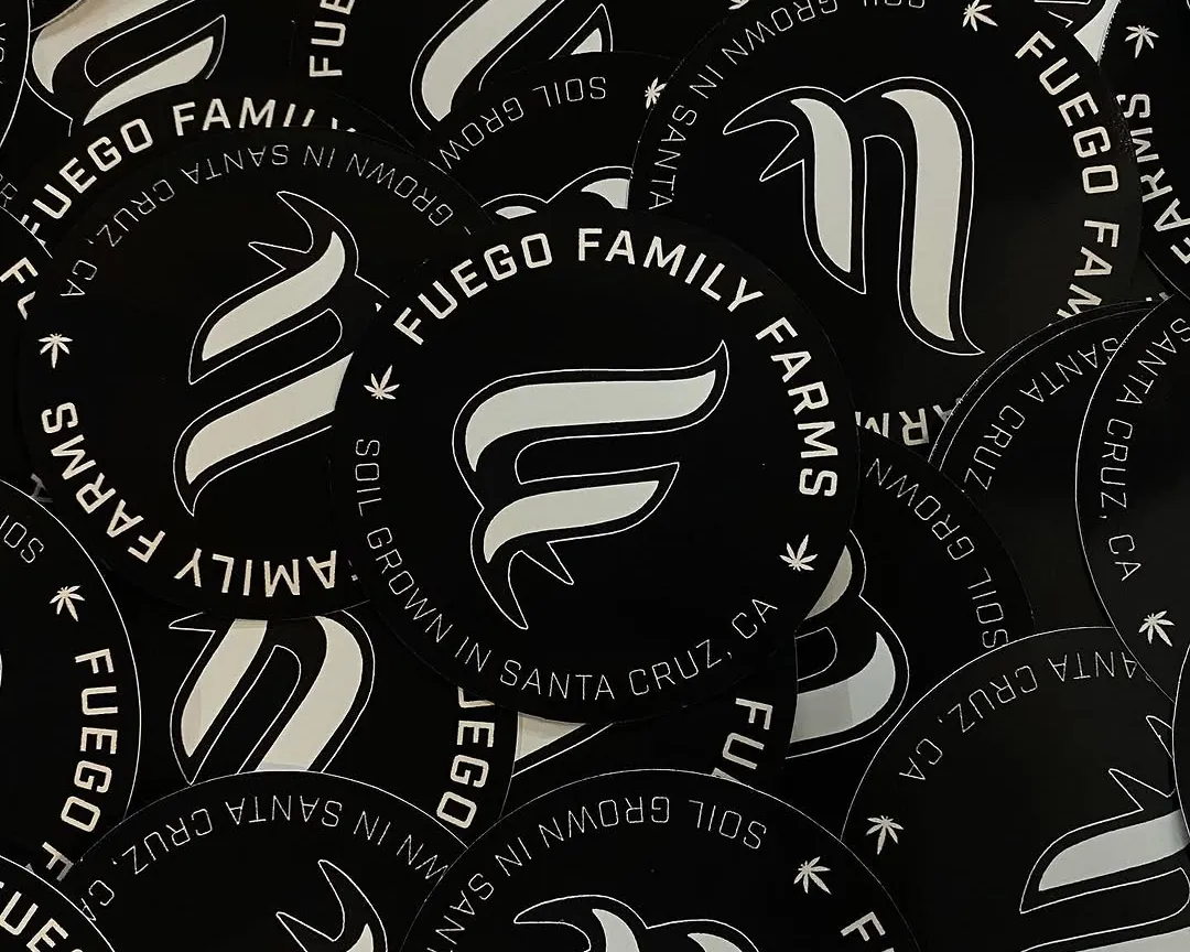 A pile of round black Fuego Family Farms labels