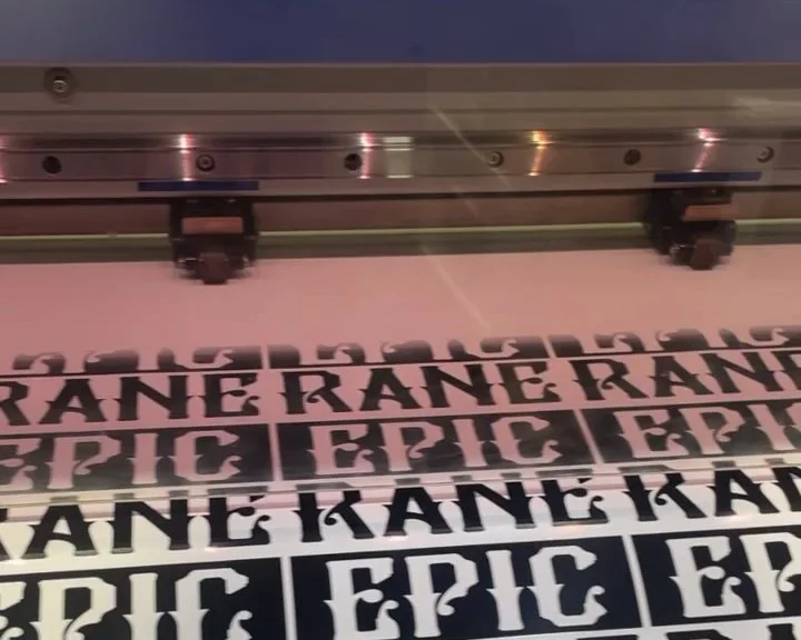 Epic Rane stickers printing as a sheet run under the press carriage