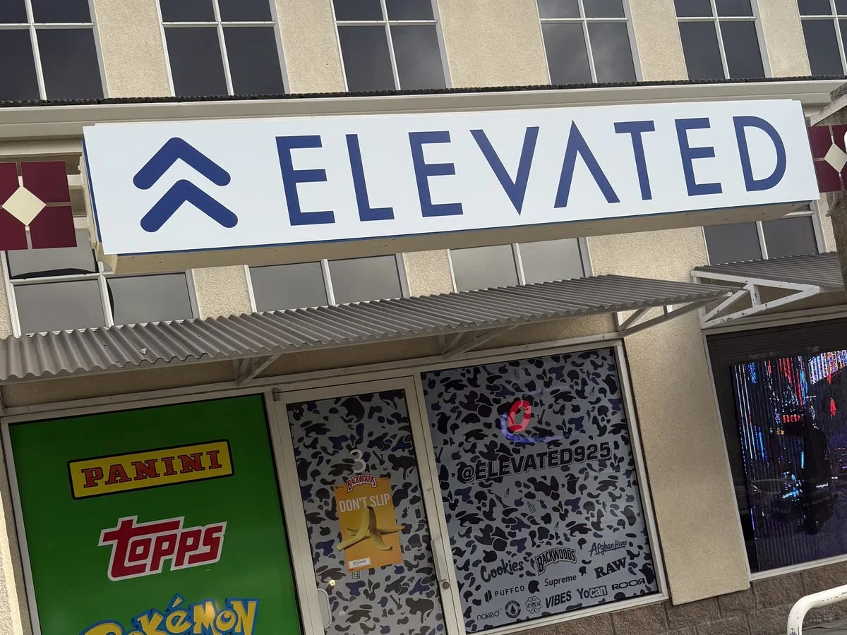 Elevated storefront sign above window graphics