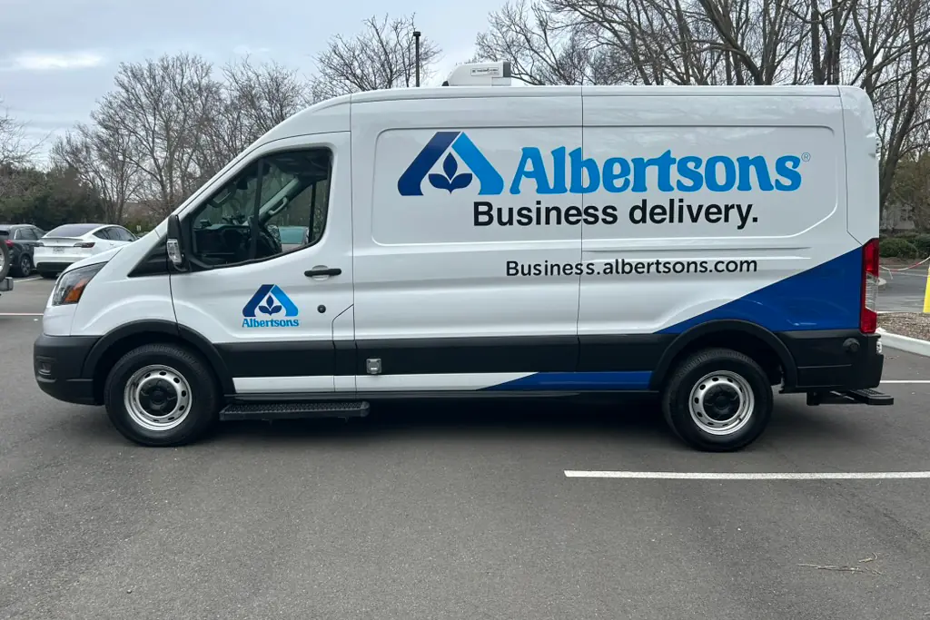 White Albertsons business delivery van with blue fleet graphics